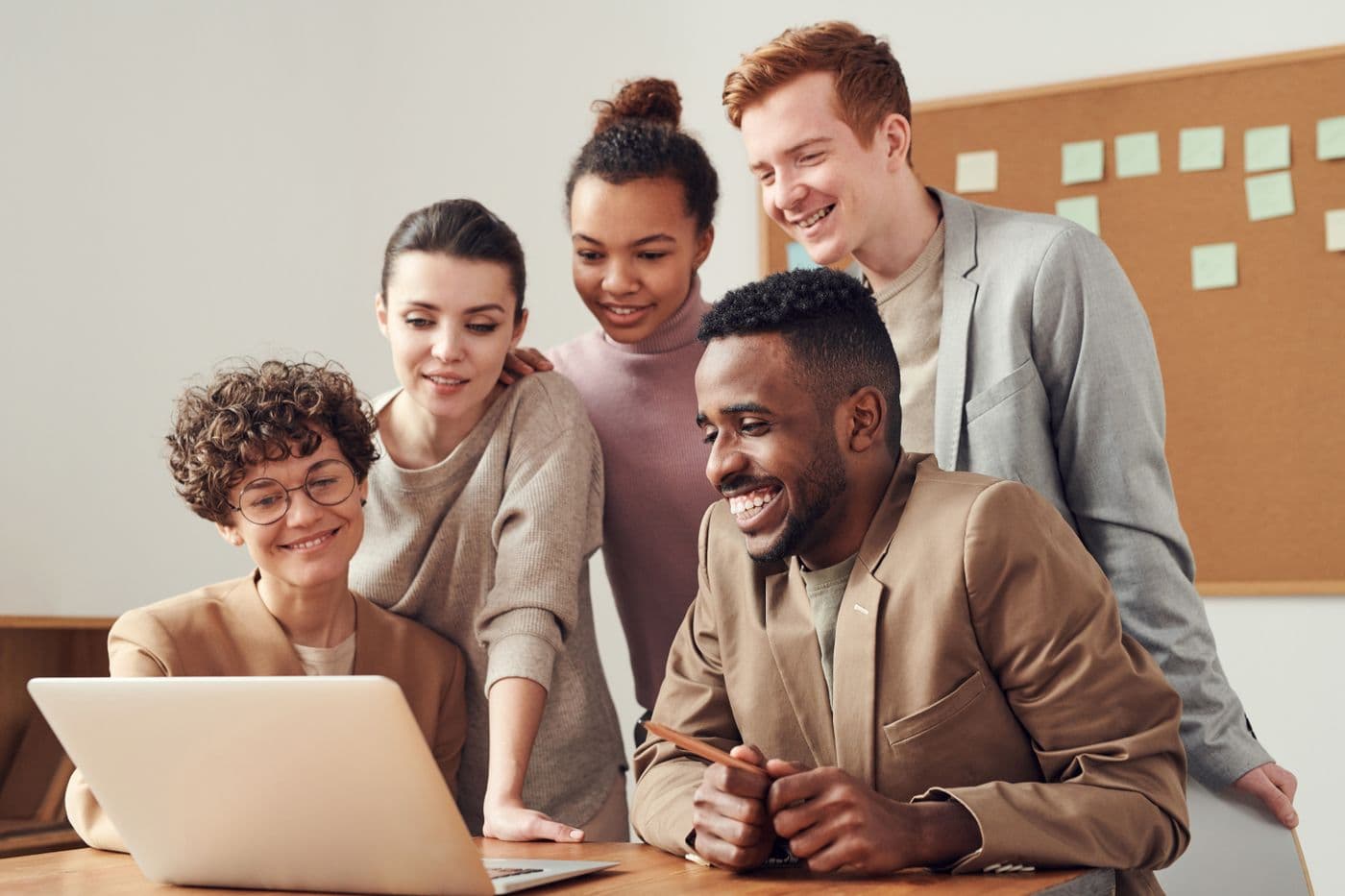 A small team reviewing results together around a laptop